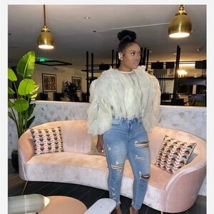 Cream ruffle long sleeve shirt.